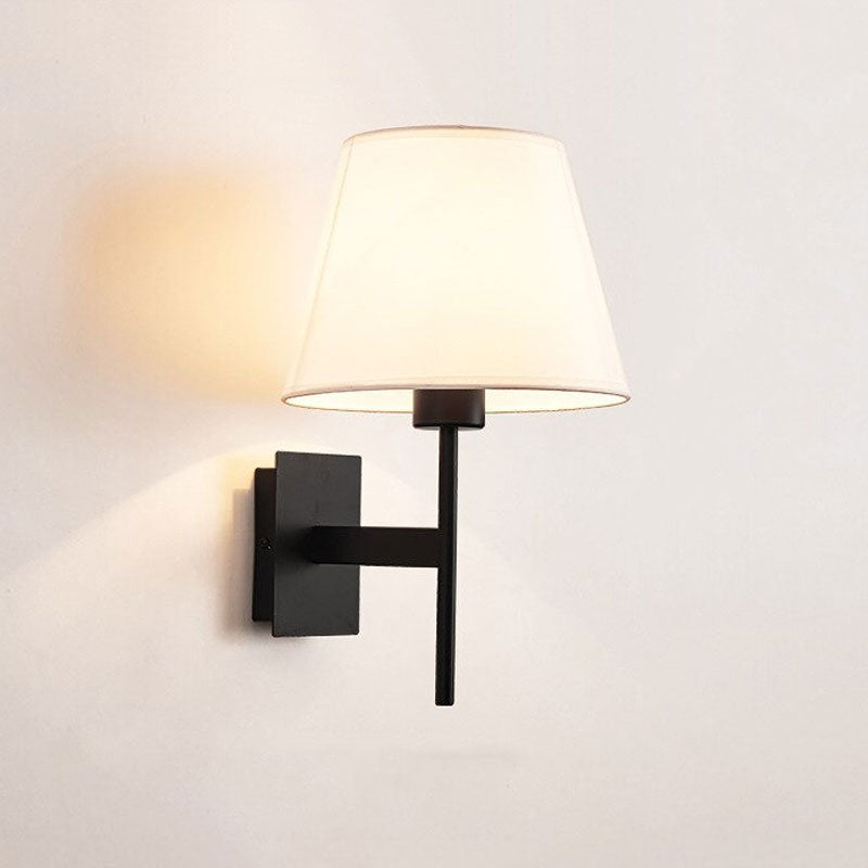 Warm accent lighting radiates from a white fabric shade for a cozy ambiance.
