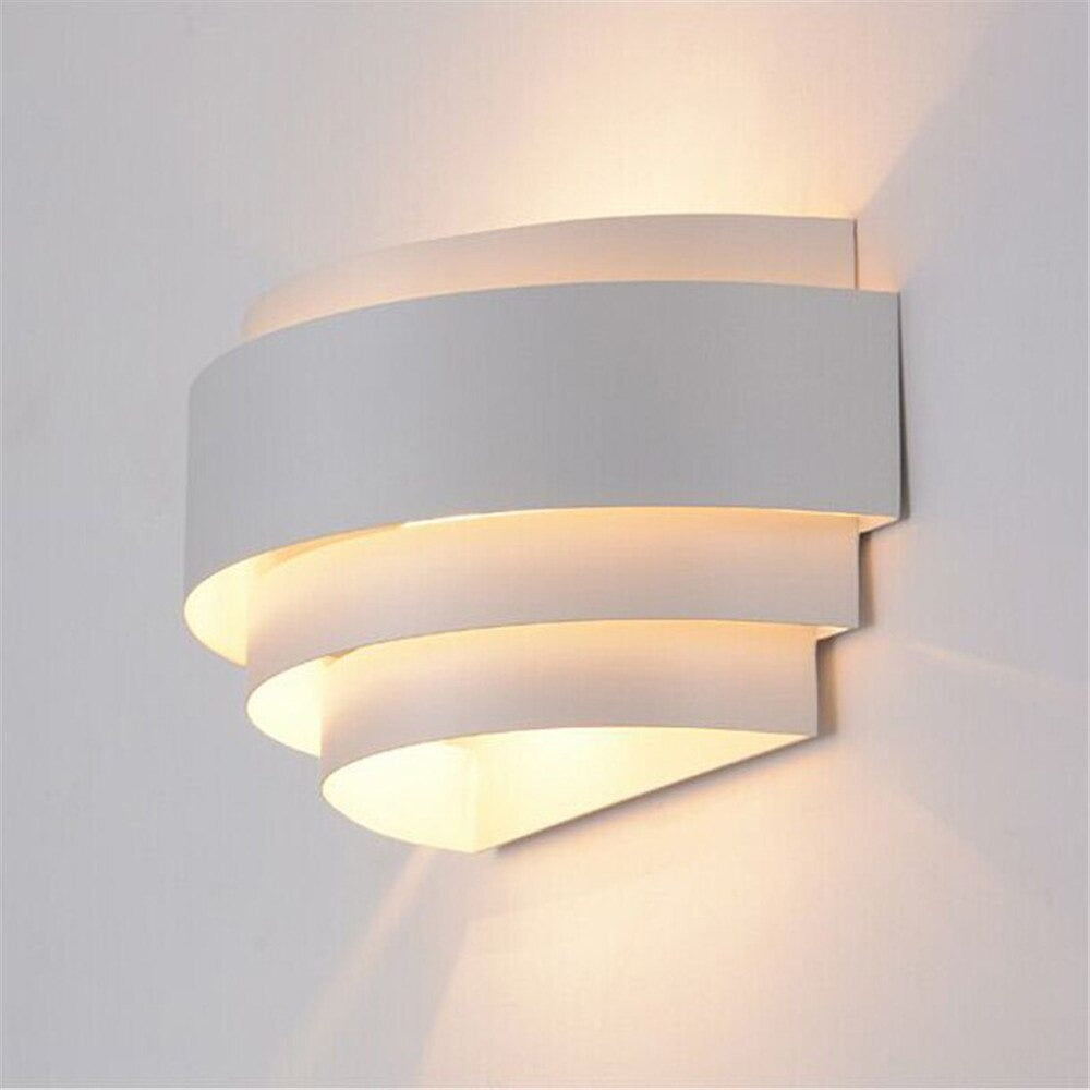 Integrated LEDs emit soft, warm up-and-down lighting from minimalist white overlapping panels.