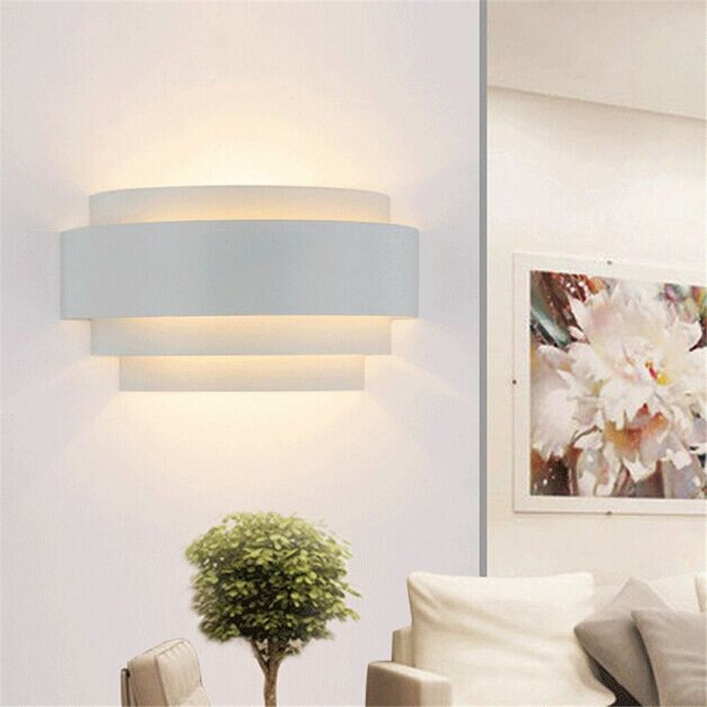The ORLUNE HOME Snail LED Wall Light casts a soft upward glow with elegant panels.