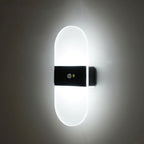 Soft white light shines from a sleek, modern LED wall fixture with sensor.