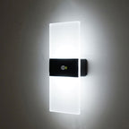 This LED wall light emits crisp, bright white light through frosted glass panels.