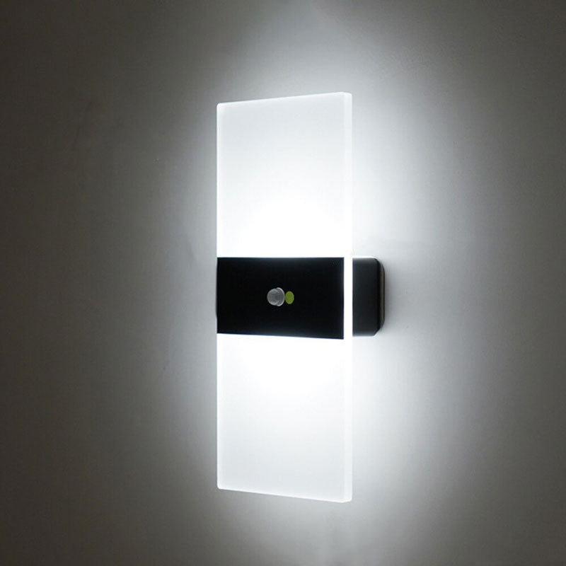 This LED wall light emits crisp, bright white light through frosted glass panels.
