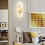 Soft, minimalist circular LED wall light casts gentle illumination in the modern space.
