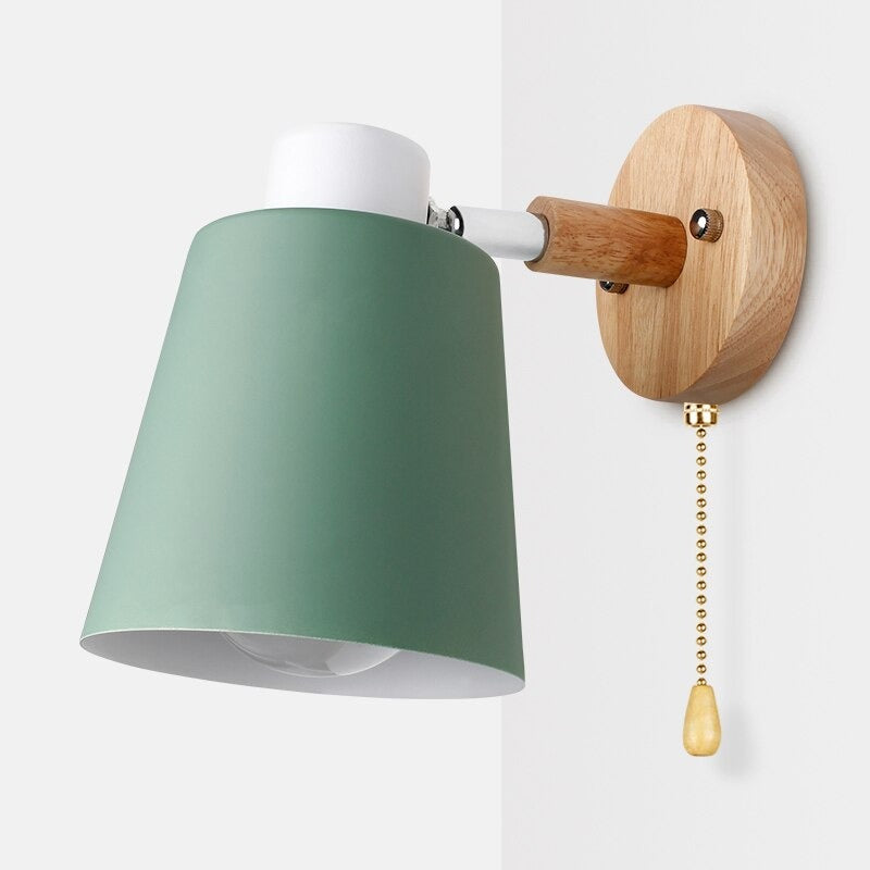 Warm glow from green-shaded wall light enhances ambiance with a stylish wood-and-gold design.