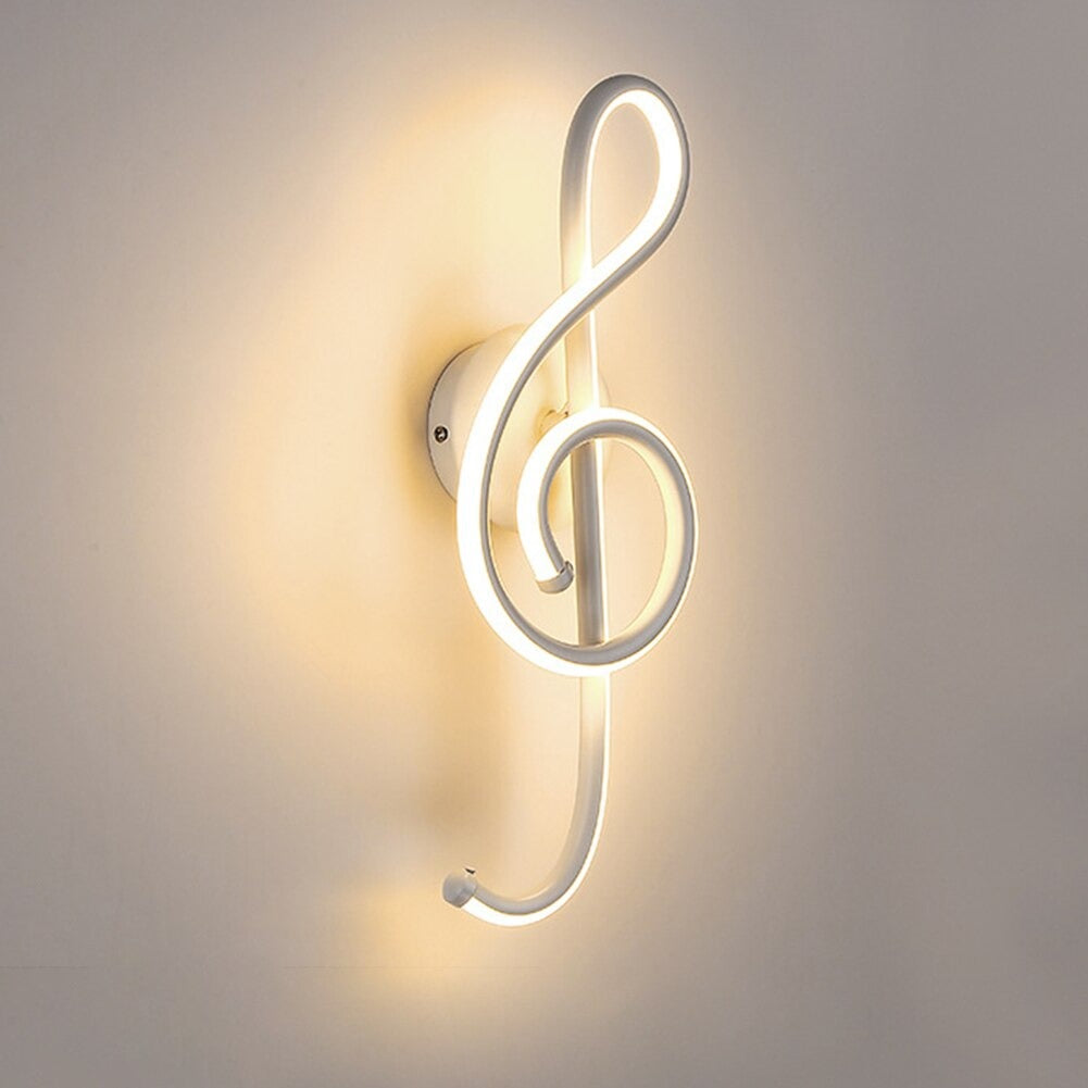 Glowing treble clef LED wall light emits a warm, elegant ambient glow.