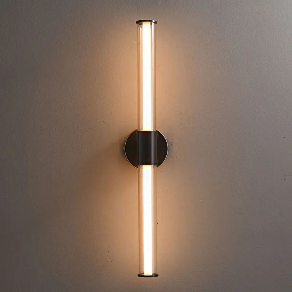 A sleek LED wall light with a soft, warm glow enhances bathroom illumination.