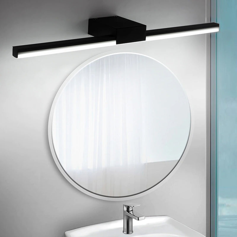 Soft LED wall light and gentle natural light combine for elegant bathroom illumination.