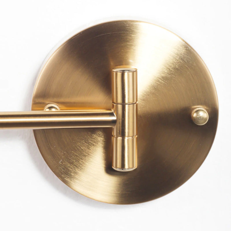 Retro golden wall light with a swivel arm, perfect for adding elegant illumination.