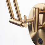 Golden industrial wall light offers focused, elegant illumination for any room.
