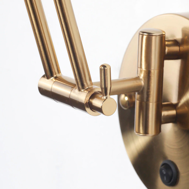 Golden industrial wall light offers focused, elegant illumination for any room.