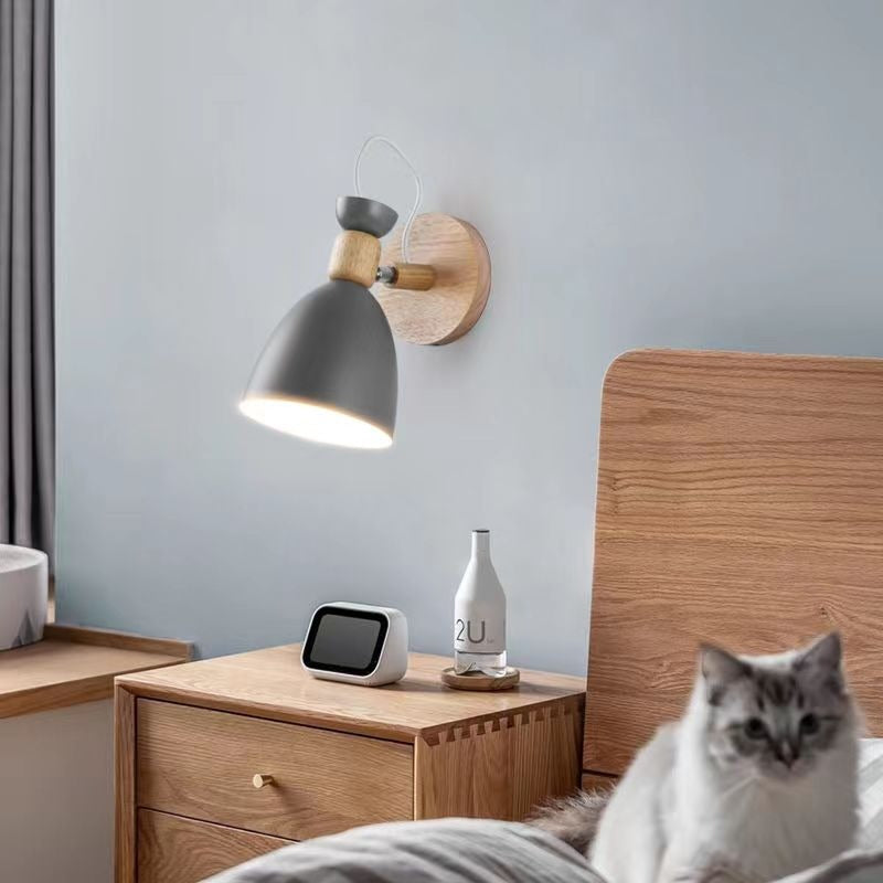 Soft, adjustable Scandinavian wood wall light casts a warm, tranquil glow above the nightstand.