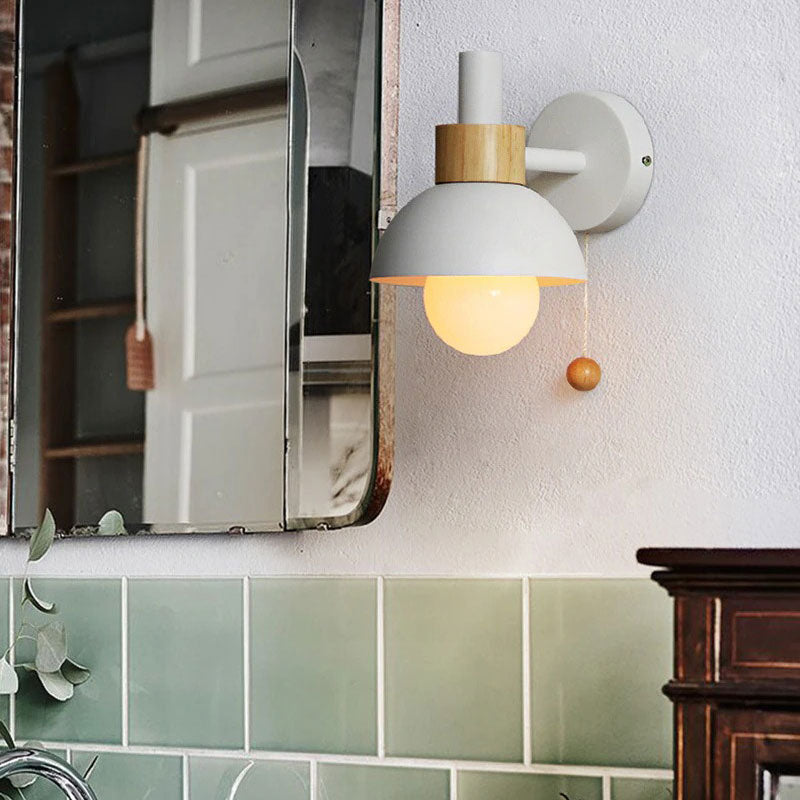 Warm, inviting light shines from a white and wood fixture with a round pull string.