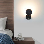 Warm light glows from the ORLUNE HOME Minimalist Round LED Adjustable Wall Light.