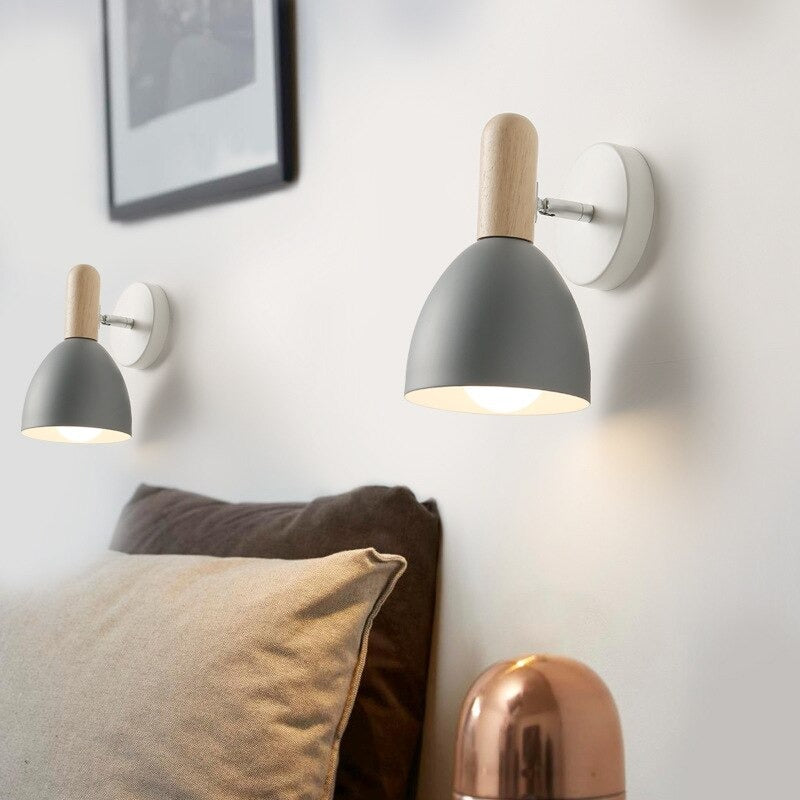 Scandinavian wooden wall light and copper lamp add warmth with their inviting glow.