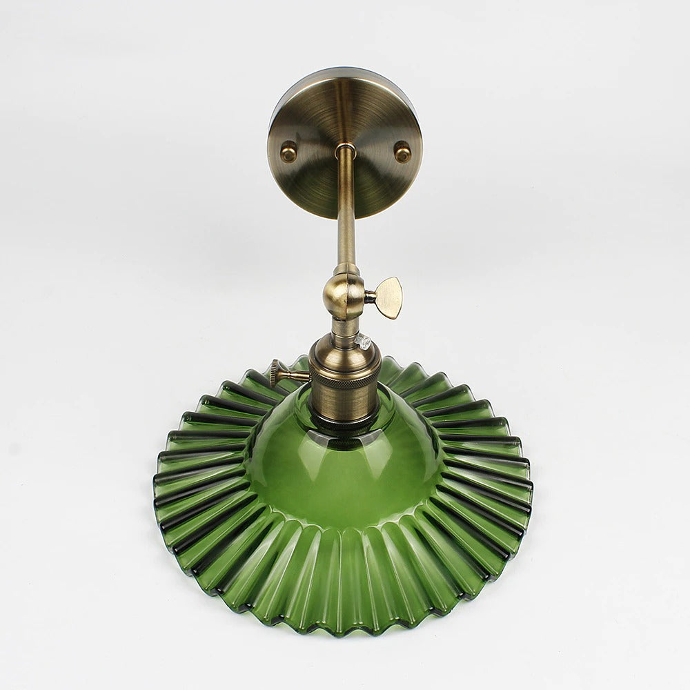 Elegant brass and creped green glass wall light delivers stunning vintage-inspired illumination.