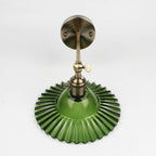 Elegant brass and creped green glass wall light delivers stunning vintage-inspired illumination.