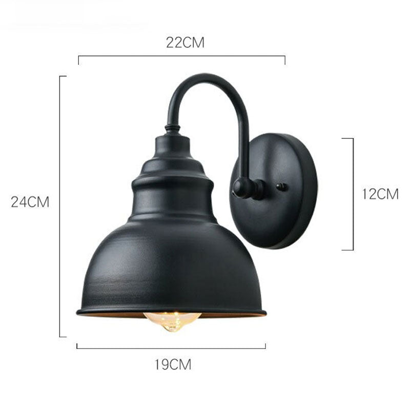 Black dome shade and visible bulb cast atmospheric vintage-style outdoor lighting.