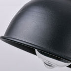 Black industrial metal wall light with exposed bulb delivers focused, retro-inspired illumination.