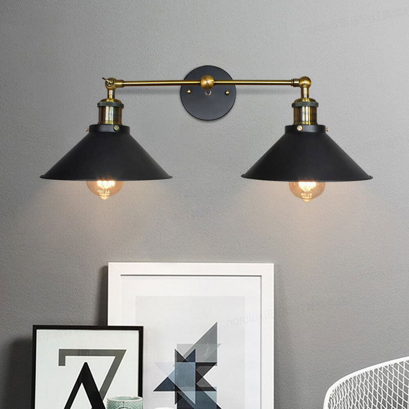 The ORLUNE HOME wall light casts dramatic, focused illumination with its black and brass finish.