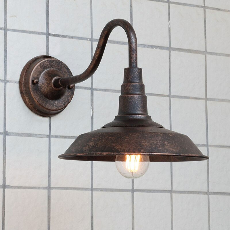Bold exposed bulb and bronze shade cast striking vintage-inspired industrial illumination.
