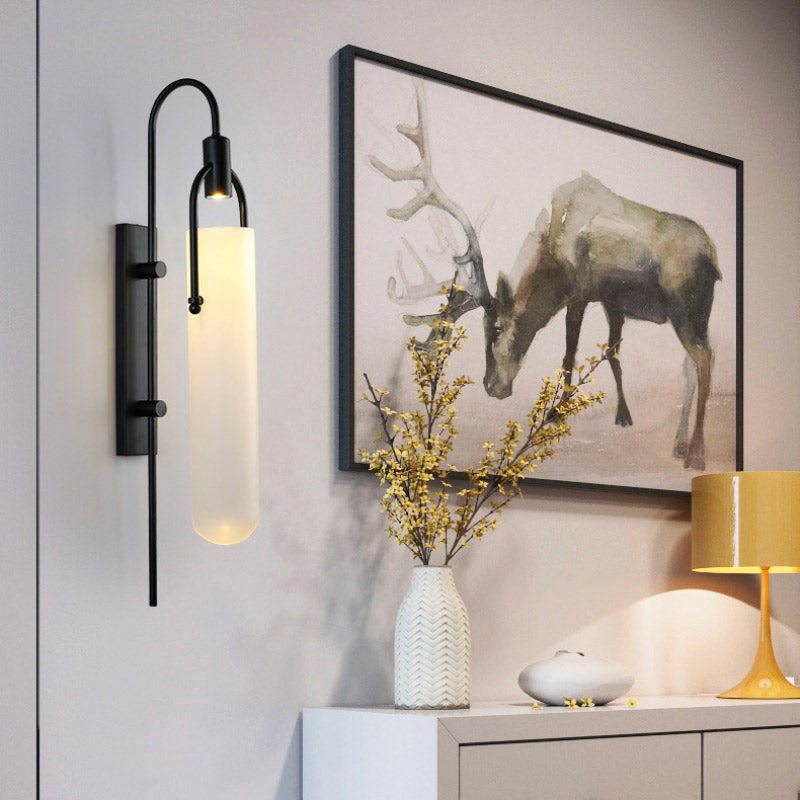 The Estane LED wall sconce with frosted glass creates a warm, modern glow.