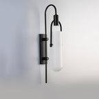 A sleek LED wall sconce provides modern, bright illumination with its glass shade.