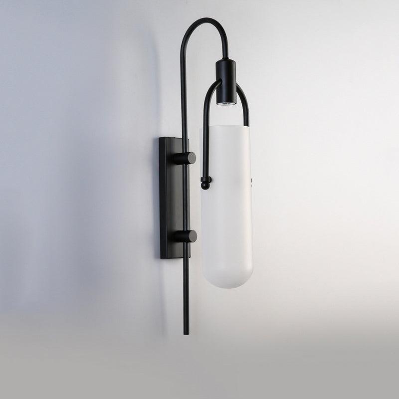 A sleek LED wall sconce provides modern, bright illumination with its glass shade.