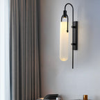 Modern LED sconce softly diffuses warm light through frosted glass for cozy ambiance.