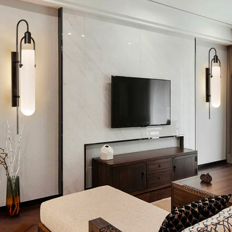 Two elegant ORLUNE HOME LED wall sconces cast soft, modern light beside the TV.