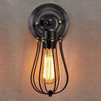 Edison bulb in black cage casts warm, soft, vintage-industrial lighting ambience.