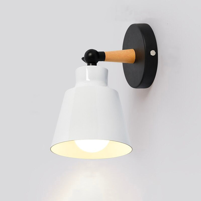 This wall light casts focused, downward illumination for a modern and industrial lighting effect.