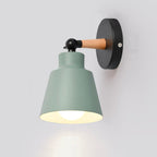 Warm downward light glows from the matte green shade, perfect for contemporary ambiance.