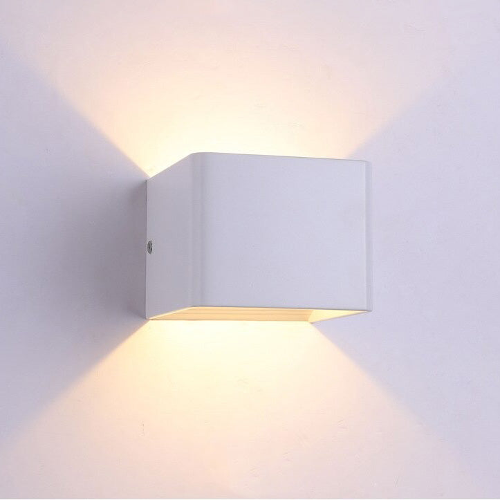 Warm LED light shines up and down, casting a gentle glow pattern on walls.