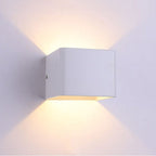 Warm LED light shines up and down, casting a gentle glow pattern on walls.