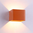 Soft orange LED light casts glowing V-shapes upward and downward on a white wall.