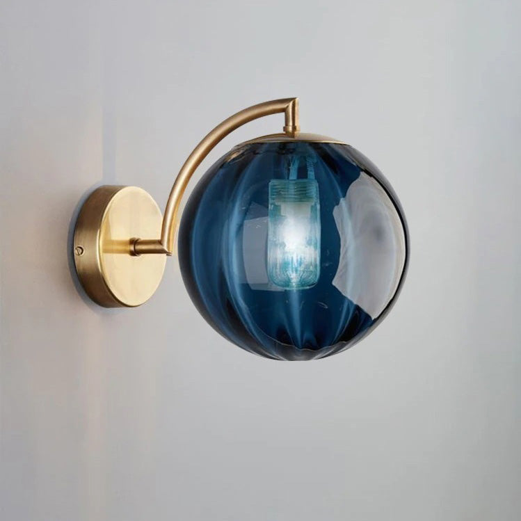 Smoked glass ball wall light emits a soft, glowing ambiance with its illuminated bulb.