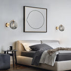 ORLUNE HOME Smoked Glass Ball Wall Lights create a modern, ambient glow above the bed.