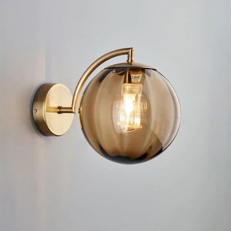 Sleek smoked glass globe and exposed bulb create chic, modern staircase lighting.