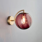 ORLUNE HOME wall light features smoked glass and brass, creating sophisticated, modern illumination.