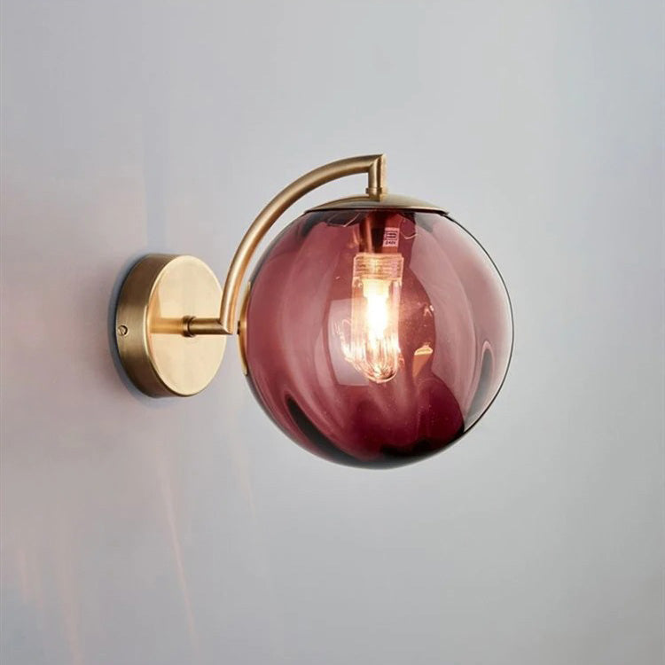 ORLUNE HOME wall light features smoked glass and brass, creating sophisticated, modern illumination.