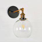 Vintage wall light pairs brass, black base, and filament bulb for striking industrial illumination.