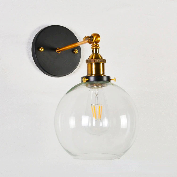 Vintage wall light pairs brass, black base, and filament bulb for striking industrial illumination.