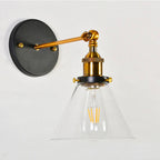 This light’s clear cone shade and gold socket showcase bright, stylish illumination.