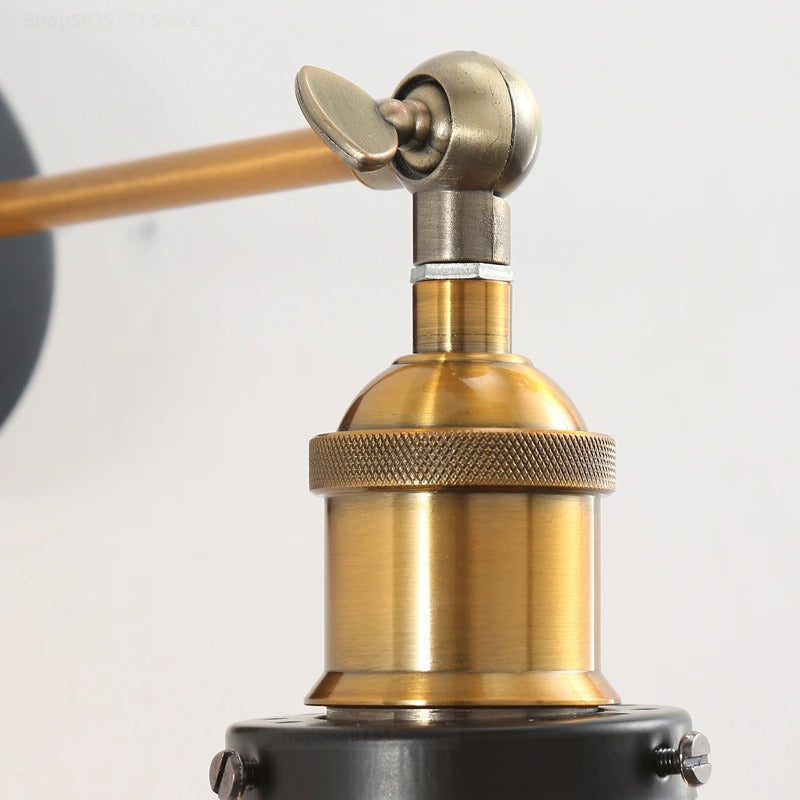 Brass joint and knurled ring on vintage wall light, spotlighting elegant illumination design.