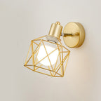 Gold geometric wire sconce offers elegant, warm illumination with a glowing white bulb.