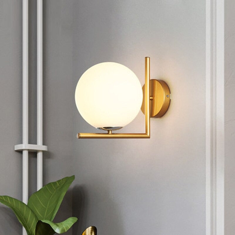 Soft glow from a white globe and gold frame adds elegance to any staircase.