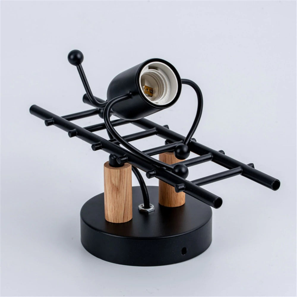This unique wall light offers industrial charm and focused illumination with its climbing humanoid bulb design.
