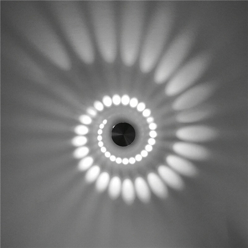 Soft LED spiral light creates radiant oval patterns and gentle circular glows on white ceilings.