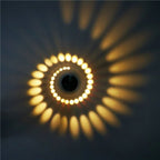 Warm yellow dots and rays from Spiral LED Wall Light create dynamic, artistic illumination.