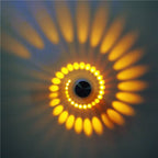 Warm yellow and orange lights radiate in a sunburst, delivering bold, ambient illumination.